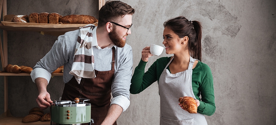 Cheerful Loving Couple Bakers Drinking Coffee